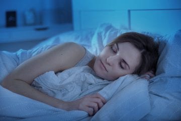 woman peacefully sleeping getting sufficient rest