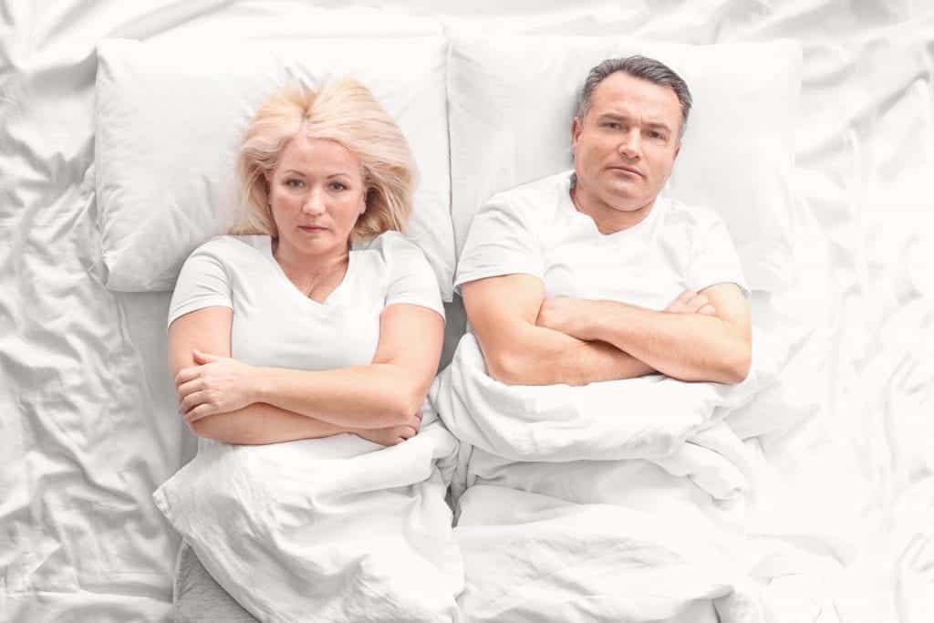 Senior couple with problem in relationship on bed